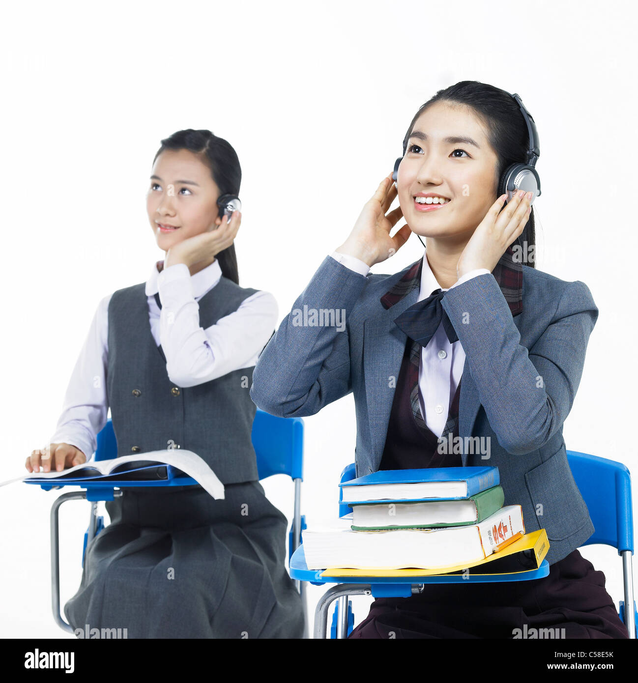 Side view of teens sitting on chair Stock Photo - Alamy
