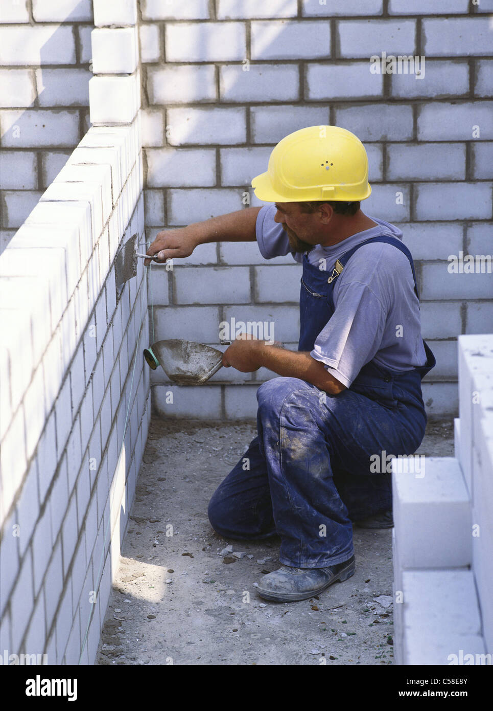 adult, architecture, brick-laying, bricklayer, building, caucasian, construction, economy, hard hat, house, housebuilding, indus Stock Photo