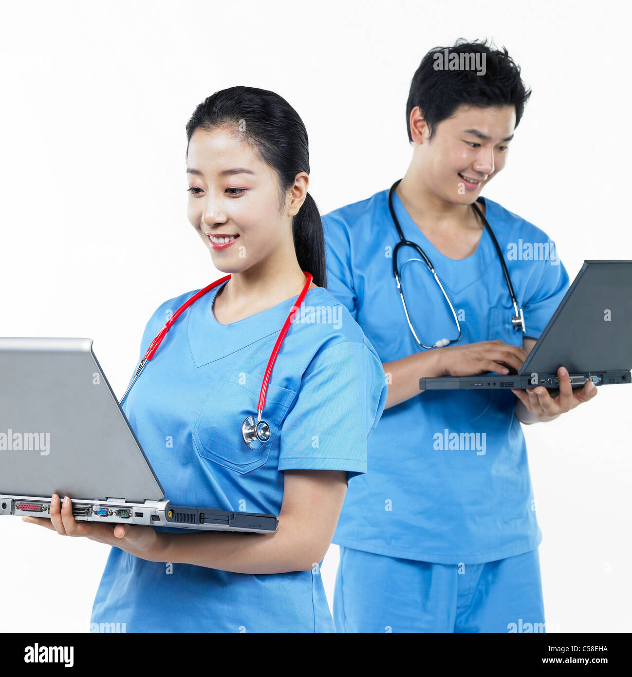 Nurse laptop typing scrubs hi-res stock photography and images - Alamy