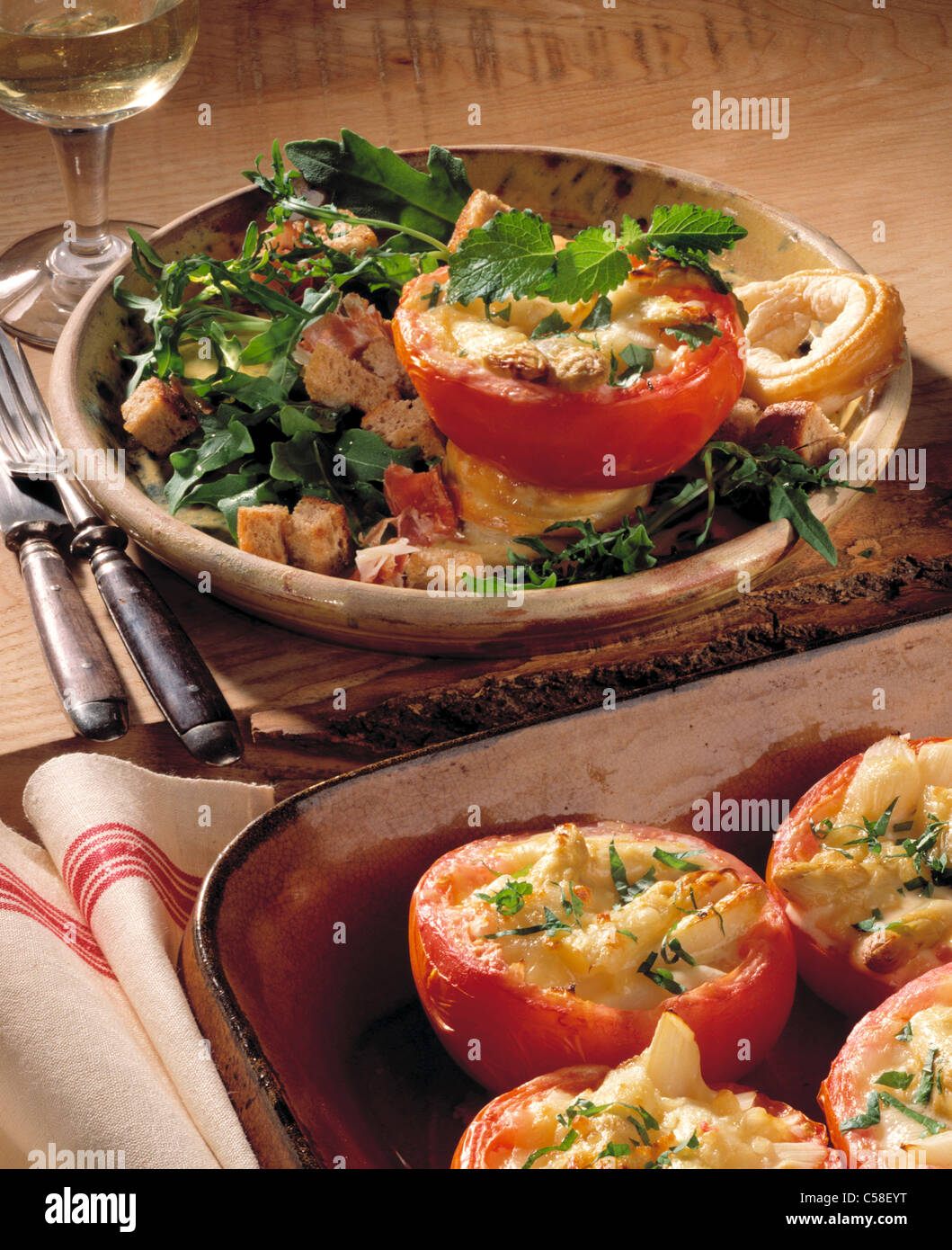 Tomatoes filled with asparagus and rucola salad on the side Stock Photo