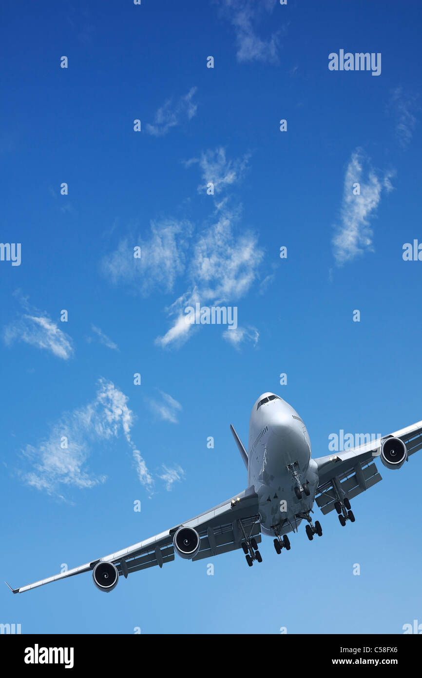 Jet aircraft is maneuvering in a blue sky Stock Photo