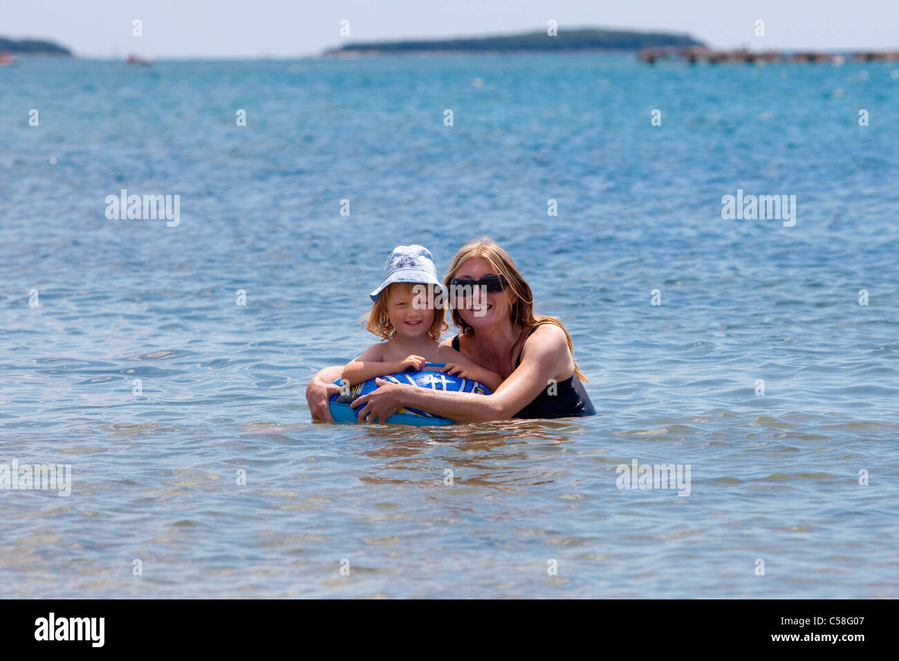 Adriatic, boy, child, coast, coastline, Croatia, day, Europe, inflatable, istra, Istria, Mediterranean, mother, ring, sea, summe Stock Photo