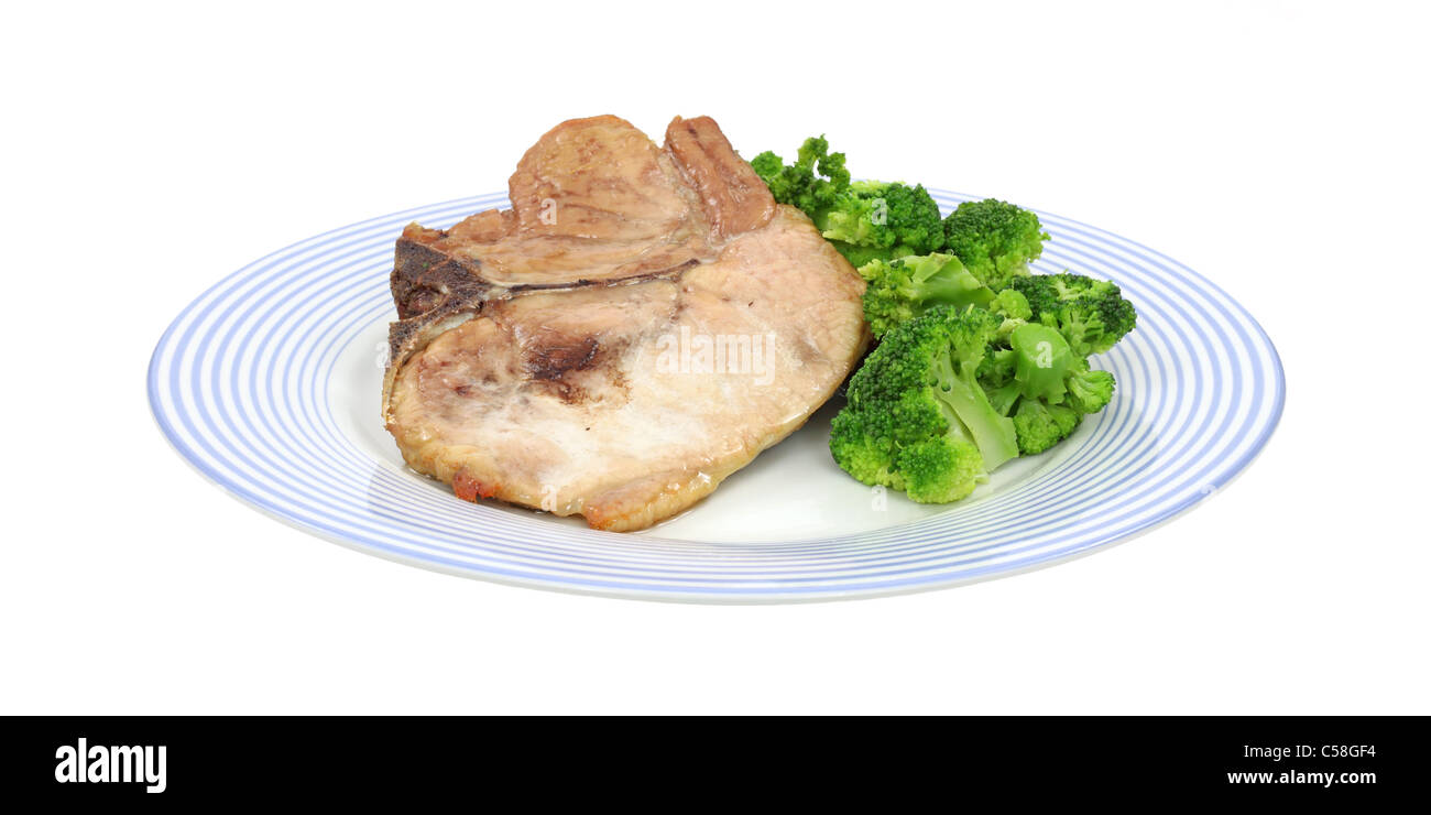 Pork chop and broccoli on dish Stock Photo