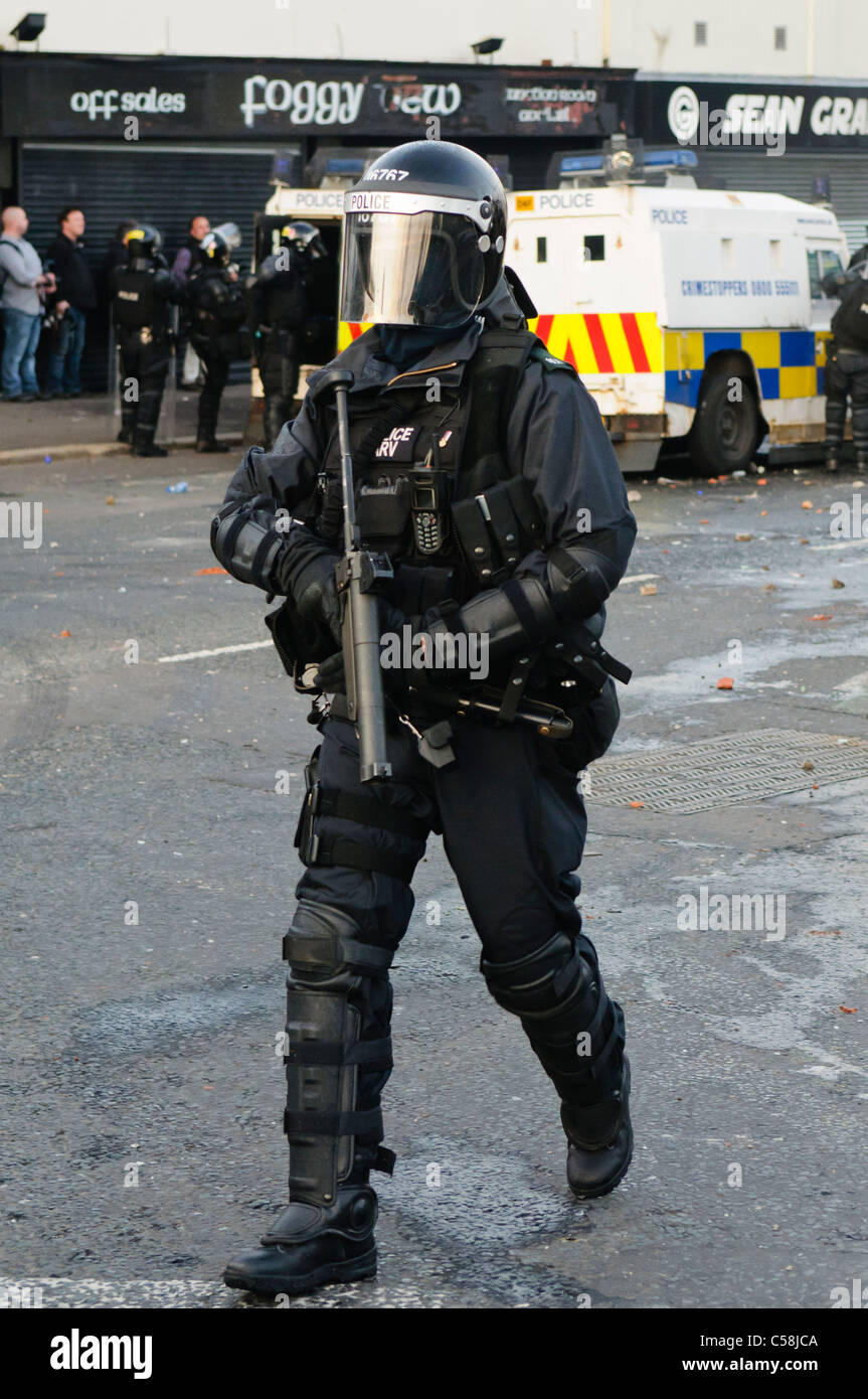 Police officer in riot gear with a Heckler and Koch L104A1 37mm single ...
