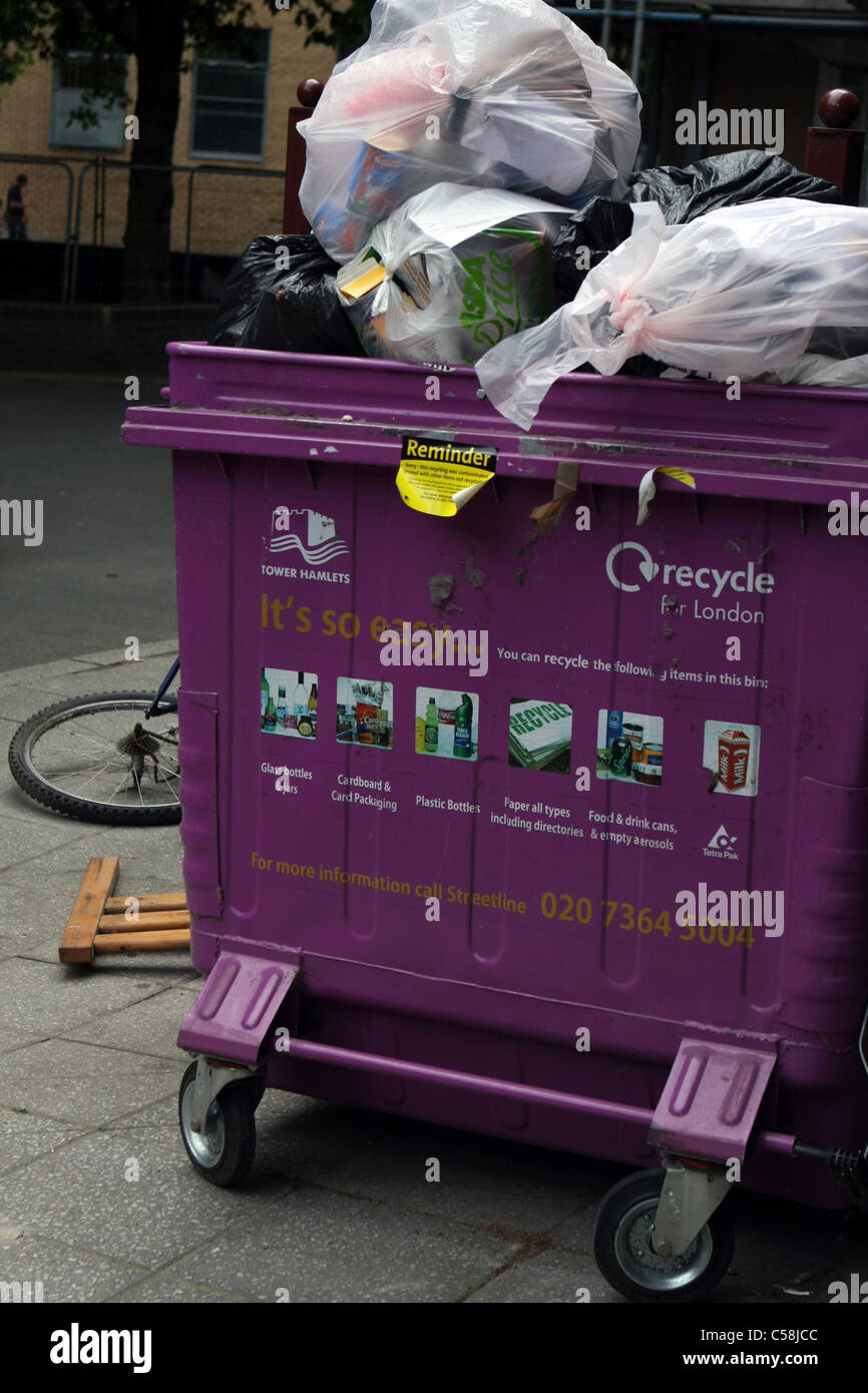 https://c8.alamy.com/comp/C58JCC/a-wheelie-bin-overflowing-with-rubbish-with-part-of-a-dumped-bicycle-C58JCC.jpg