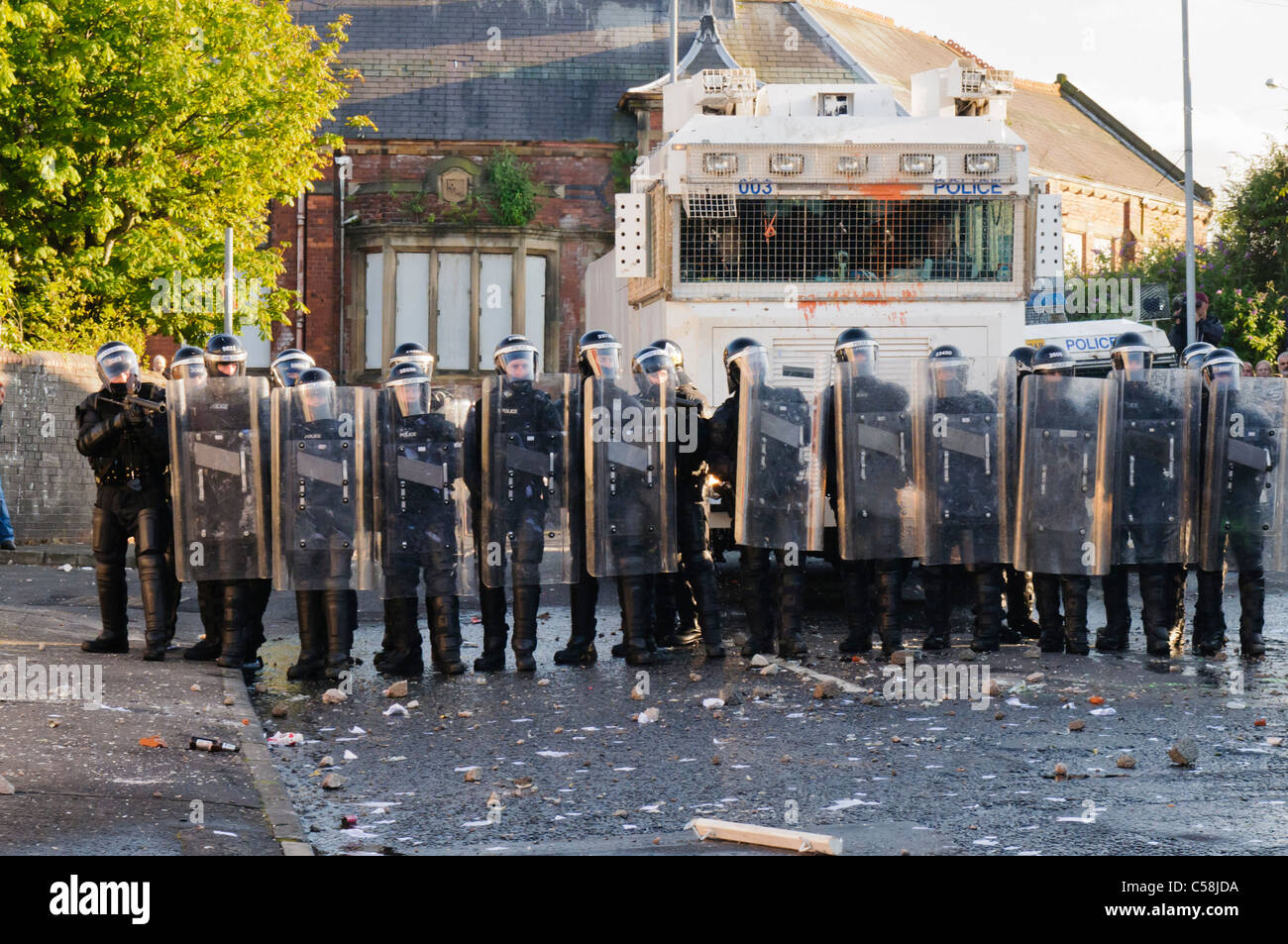 Police officers in riot gear with water cannon Stock Photo