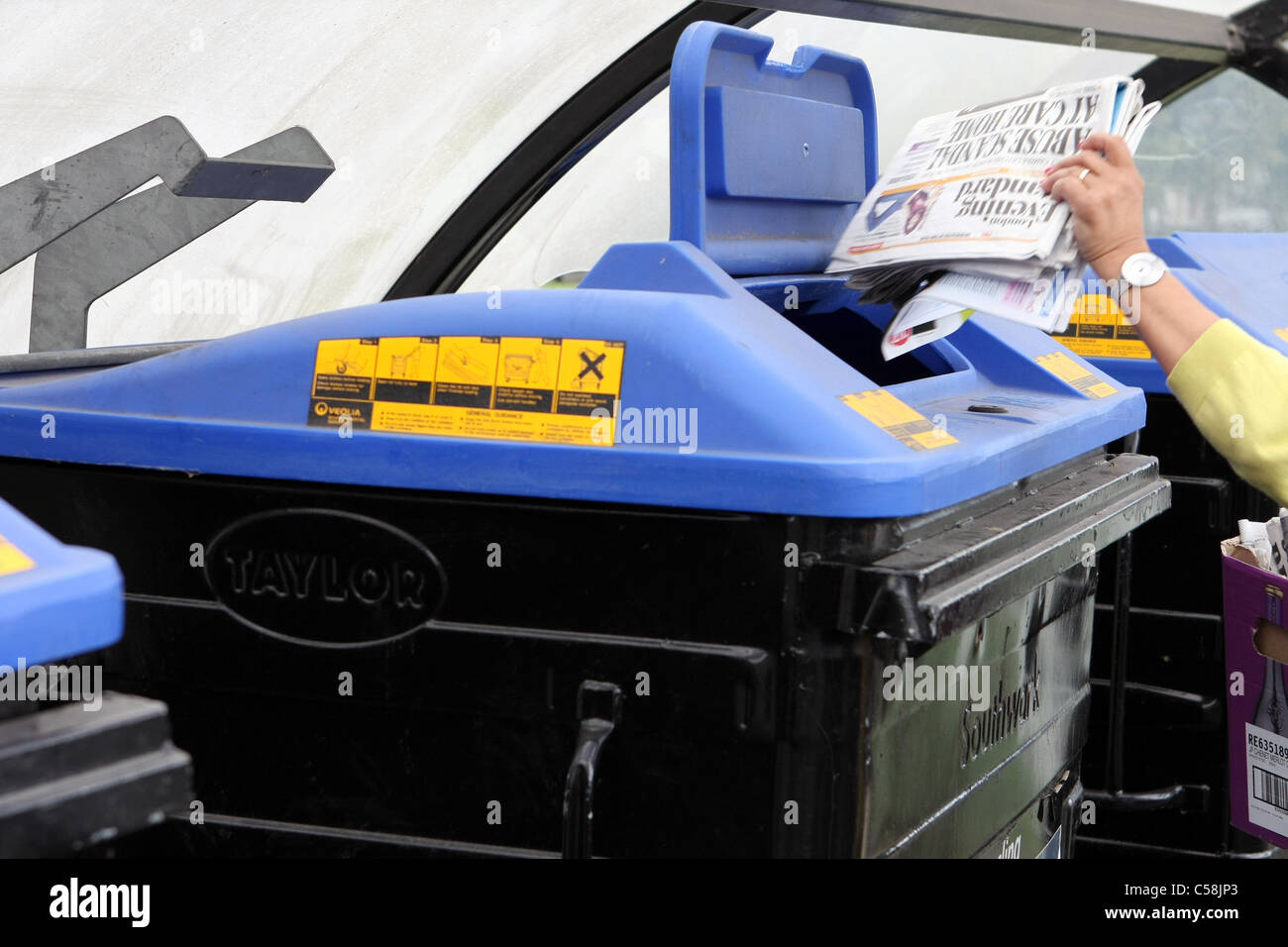 Lady putting rubbish in one hires stock photography and images Alamy