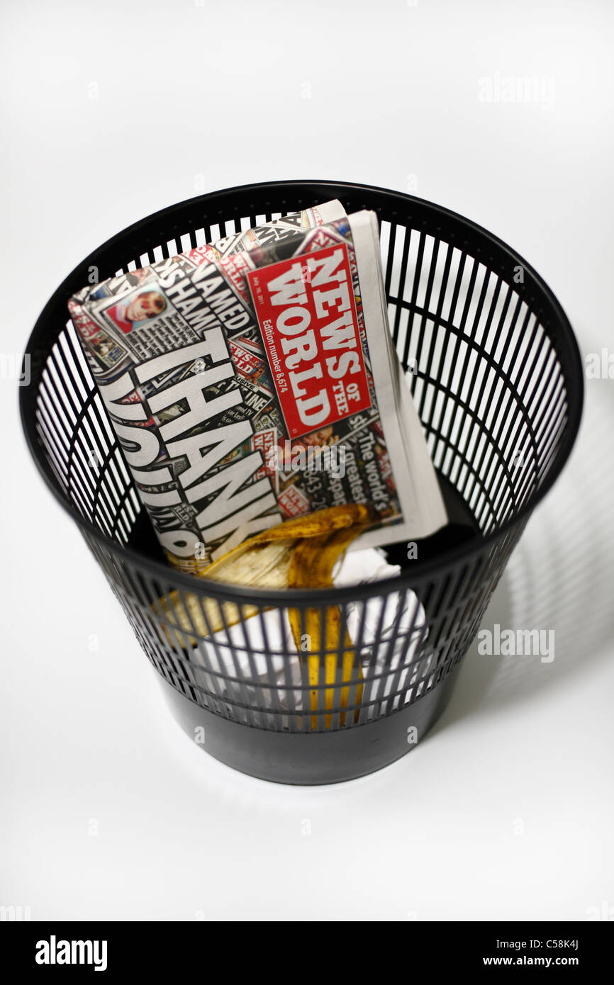 The last edition of the News of the World in the bin with the rest of the trash Stock Photo