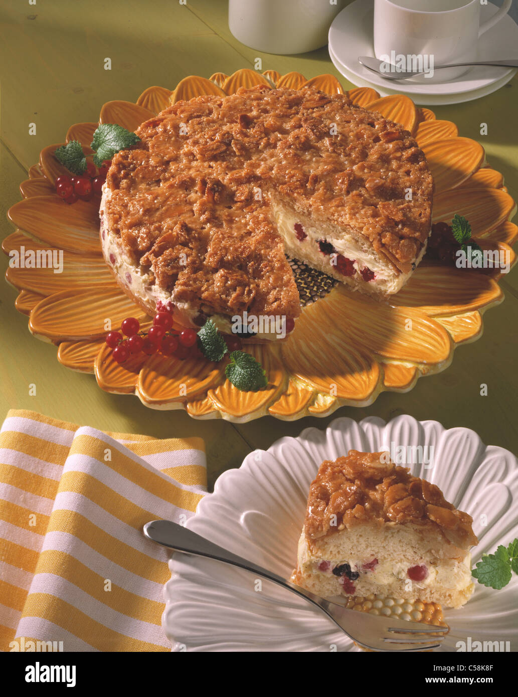 Cream filled yeast cake with berry cream and almond crust Stock Photo