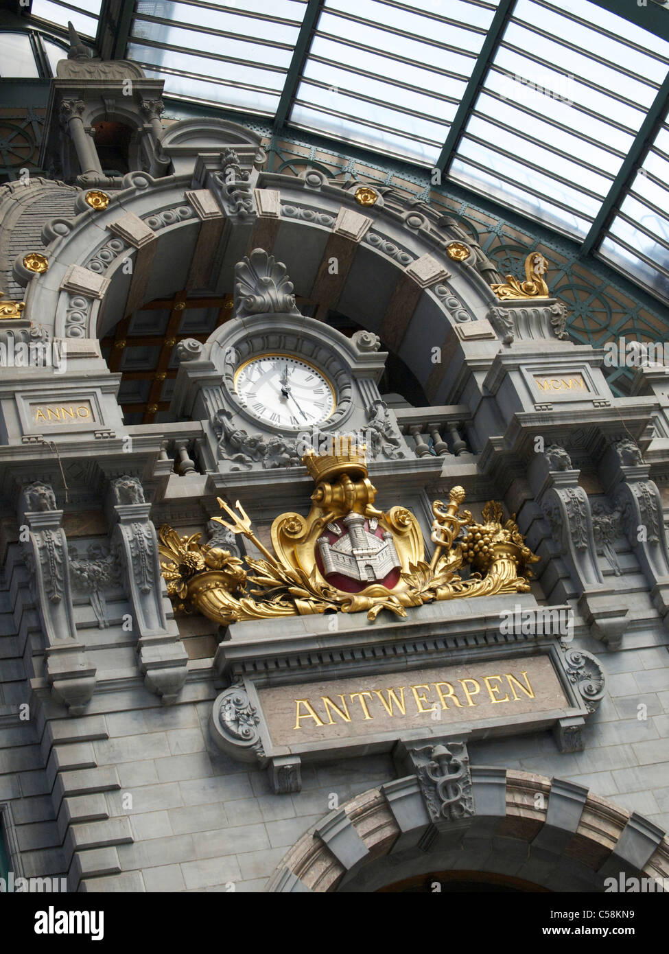 Clock in the recently renovated monumental Antwerp Central Station building, with Antwerpen name sign in gold. Stock Photo