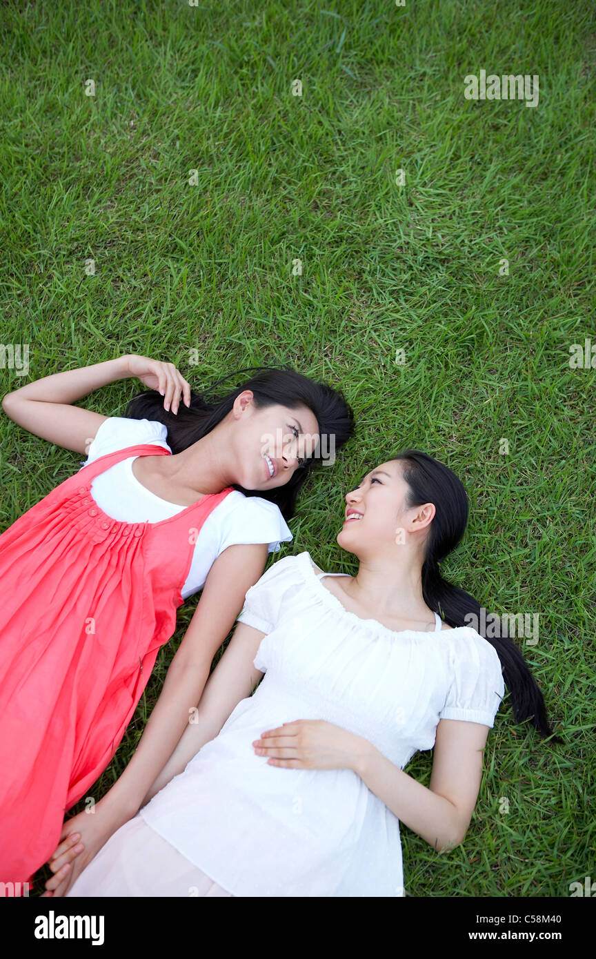 Close-up of young women lying on grass Stock Photo