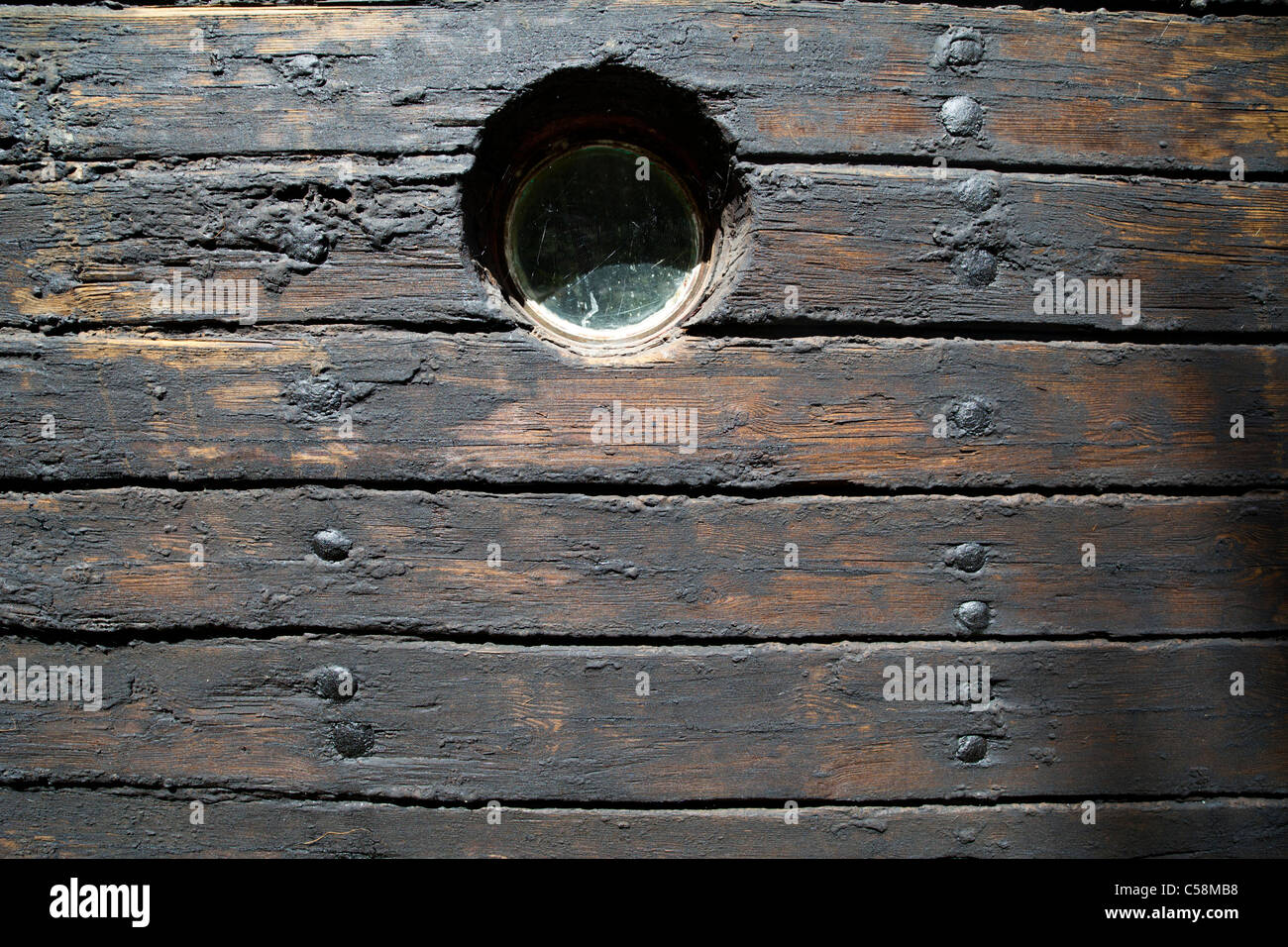 Hull boarding of an old wooden steam ship . Boards treated with tar ...