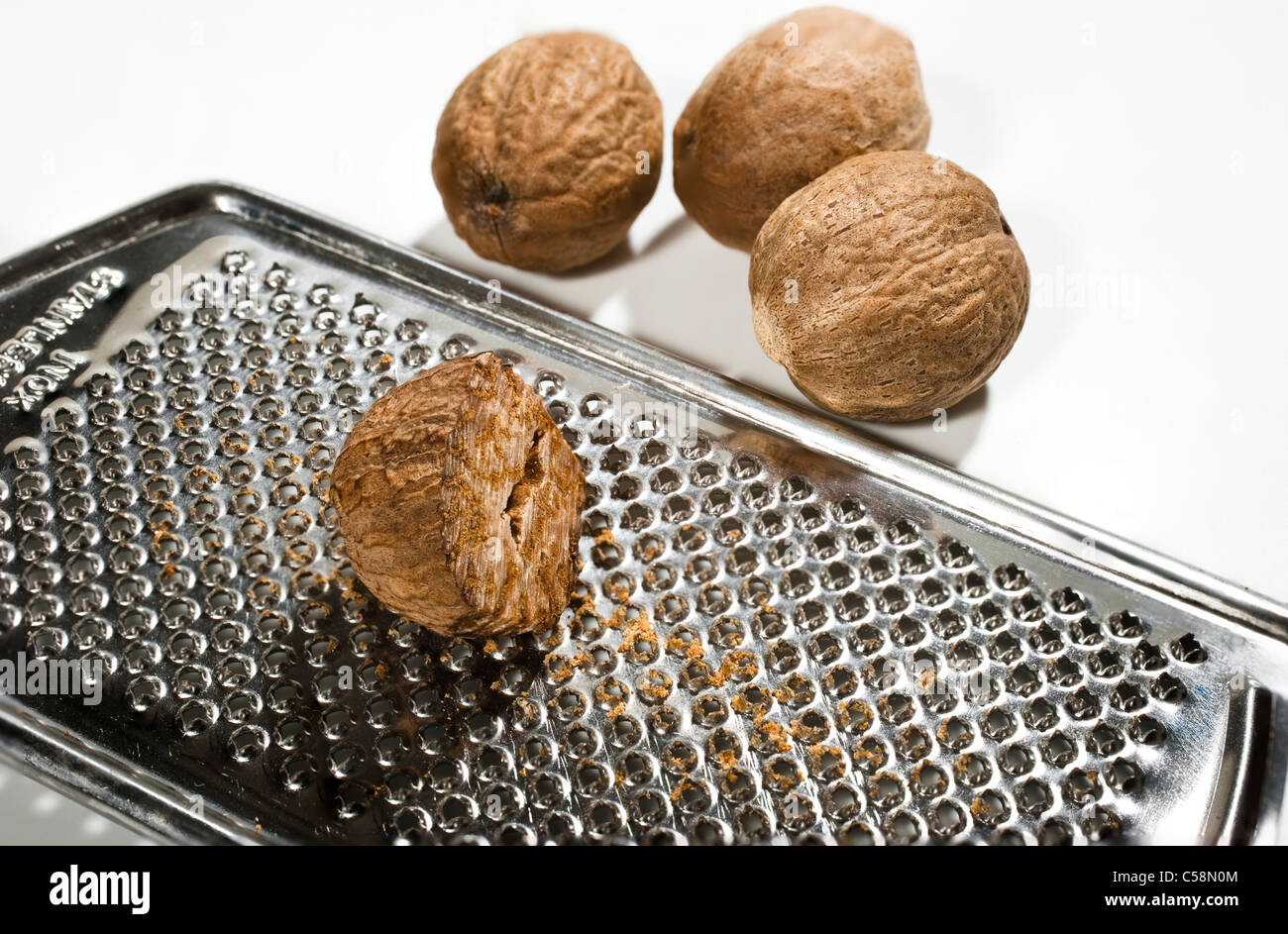 Nutmegs with a grater (Myristica Fragrans) Stock Photo