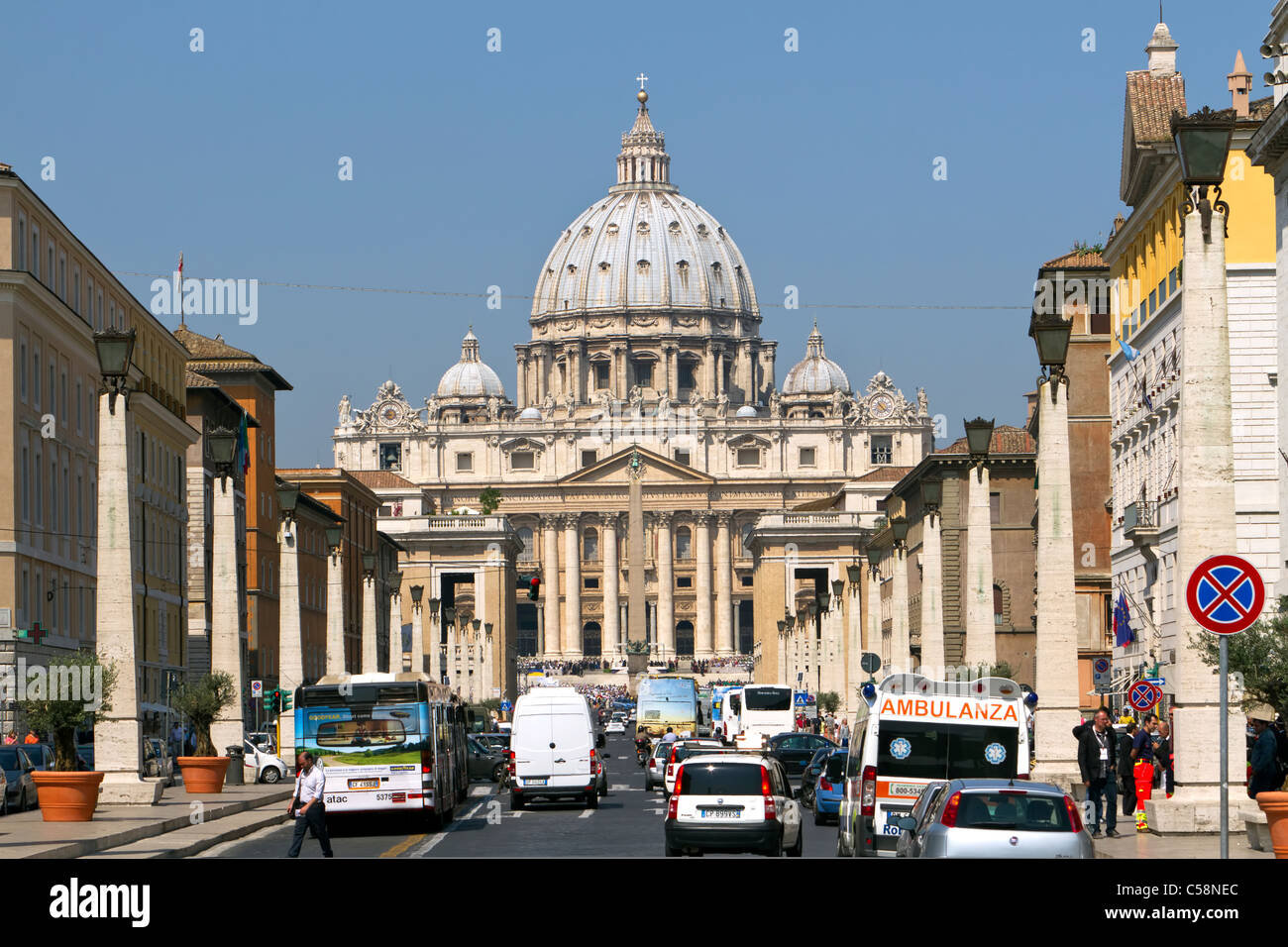 Vatican City Saint Peter's Square from down the road with traffic and tour bus. Famous courtyard and plaza. Stock Photo