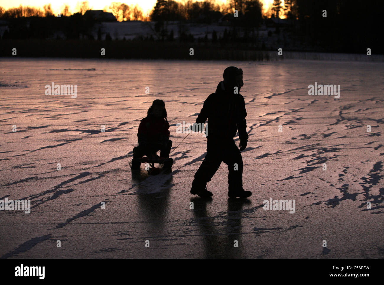 Children on the frozen Stora Bellen lake, Belloe, Sweden Stock Photo