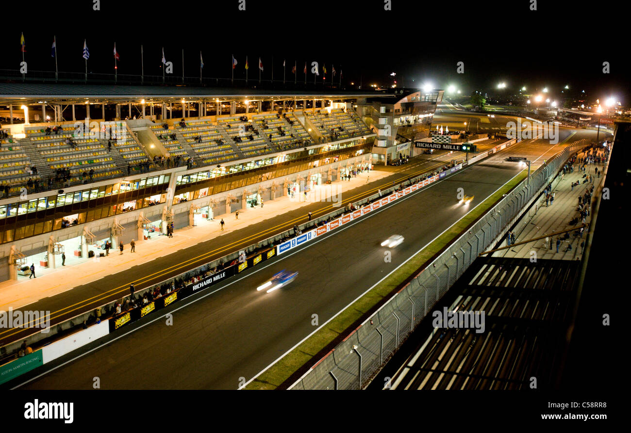 The blur of the cars as they speed down the finishing straight. Le Mans Classic Car Race. France