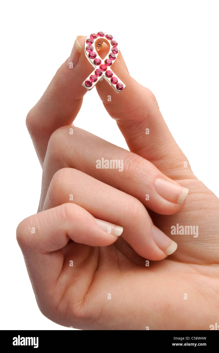 female hand holding breast cancer pin Stock Photo