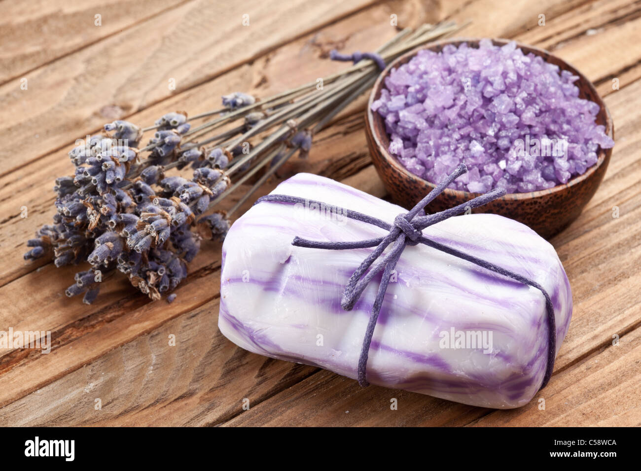 Soap with sea-salt and dried lavender on wood desk. Stock Photo