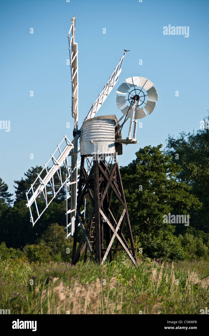 Wind driven water pump for moving water on Norfolk Broads Stock Photo