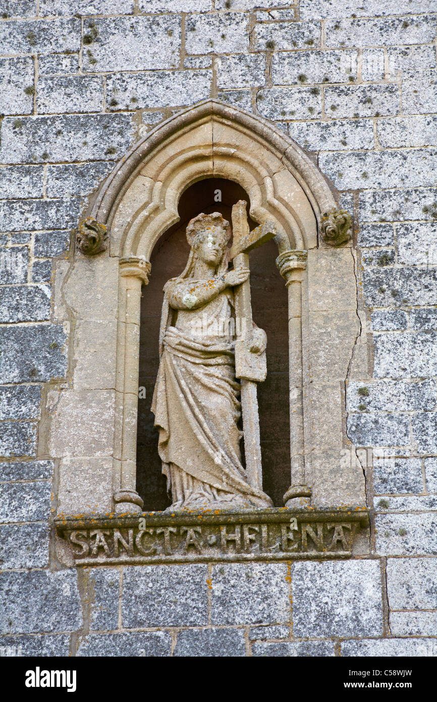 sculpture of Saint Helena holding a cross on outside of church on Lundy Island, Devon, England UK in March - St Helens Church Stock Photo