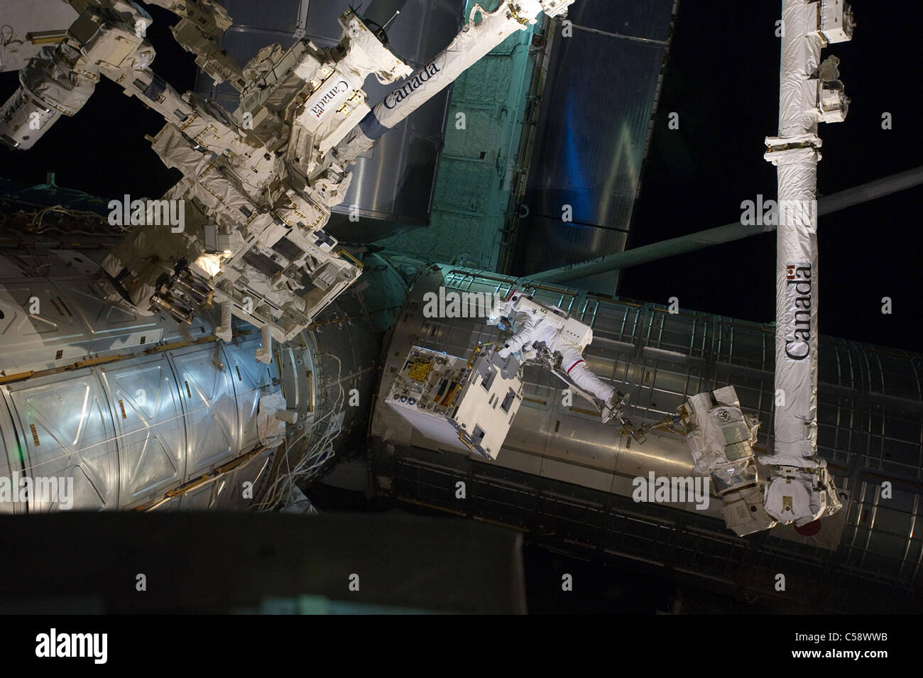 Spacewalker Mike Fossum rides on the International Space Station's ...
