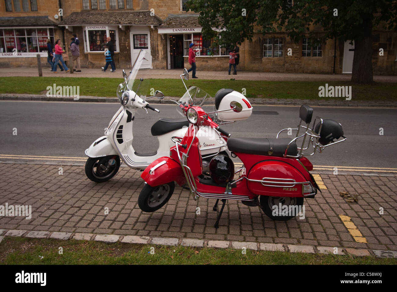 Two Vespa scooters parked at side of road in Broadway, Worcestershire Stock  Photo - Alamy