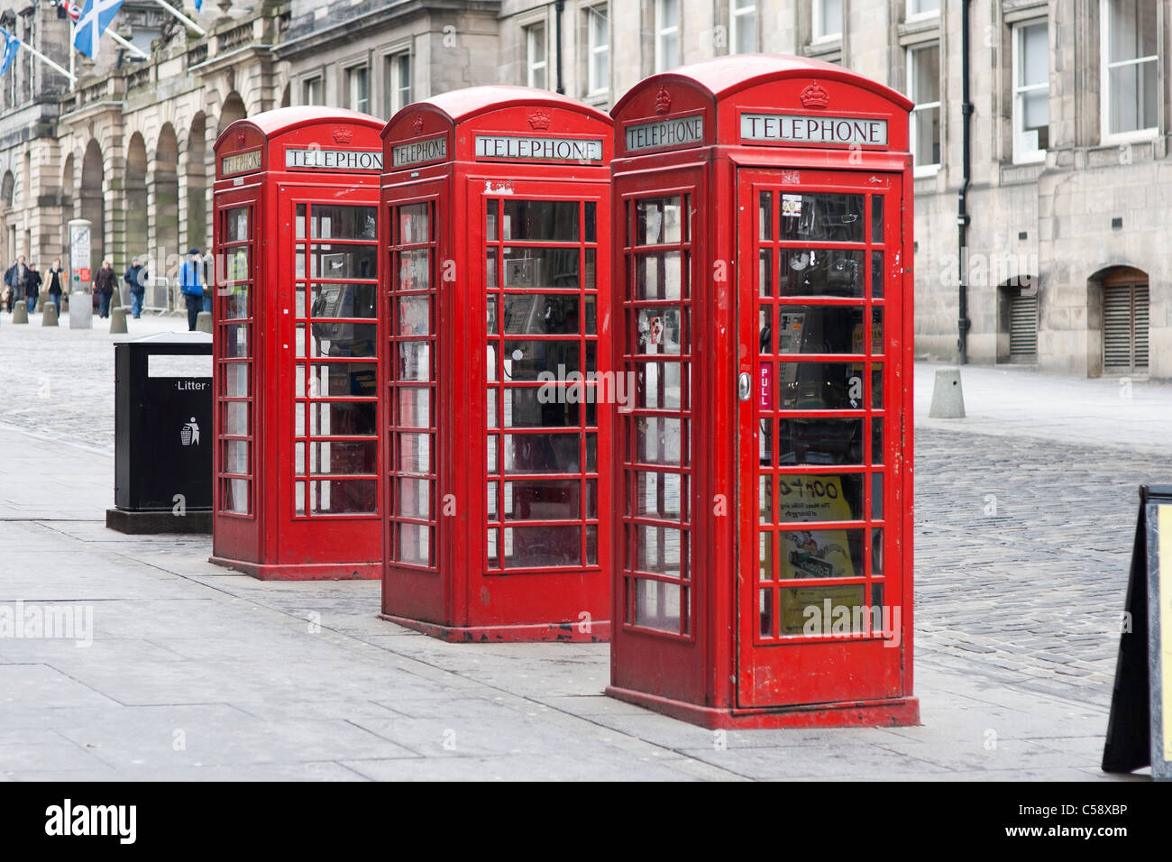 Three old fashioned British red telephone boxes on Edinburgh's High Street (Royal Mile) Stock Photo