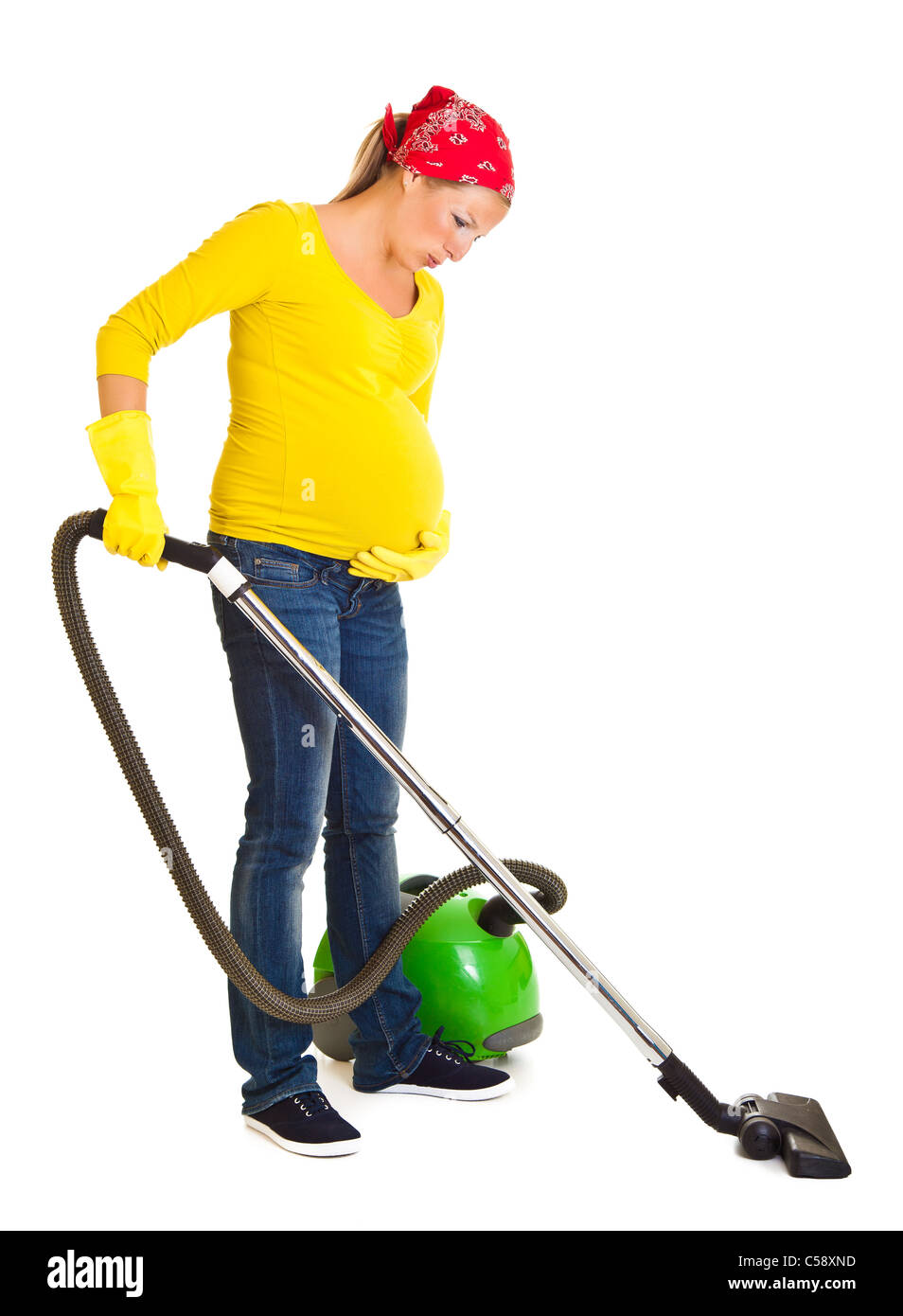 Pregnant woman clean with vacuum cleaner isolated on white Stock Photo