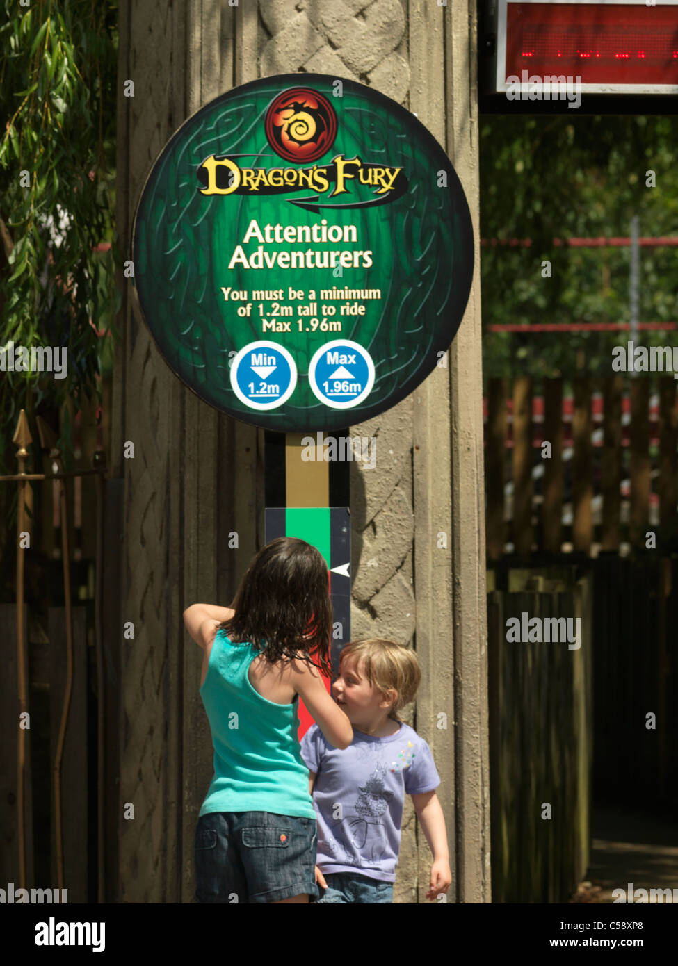 Chessington Surrey England Chessington World Of Adventures Theme Park Girls Measuring Their Height To Go On Dragon Fury Ride Stock Photo