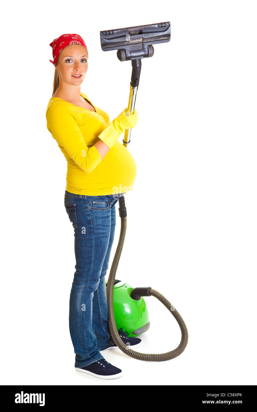 Pregnant woman clean with vacuum cleaner isolated on white Stock Photo