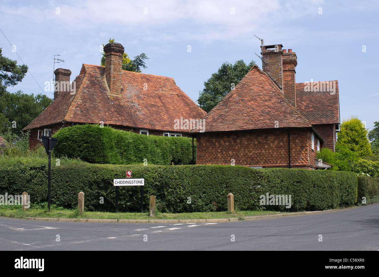 Picturesque Country Cottages With Red Tiled Roofs At A Crossroads