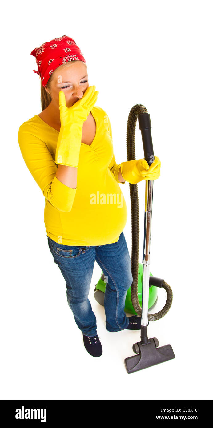 Pregnant woman clean with vacuum cleaner isolated on white Stock Photo