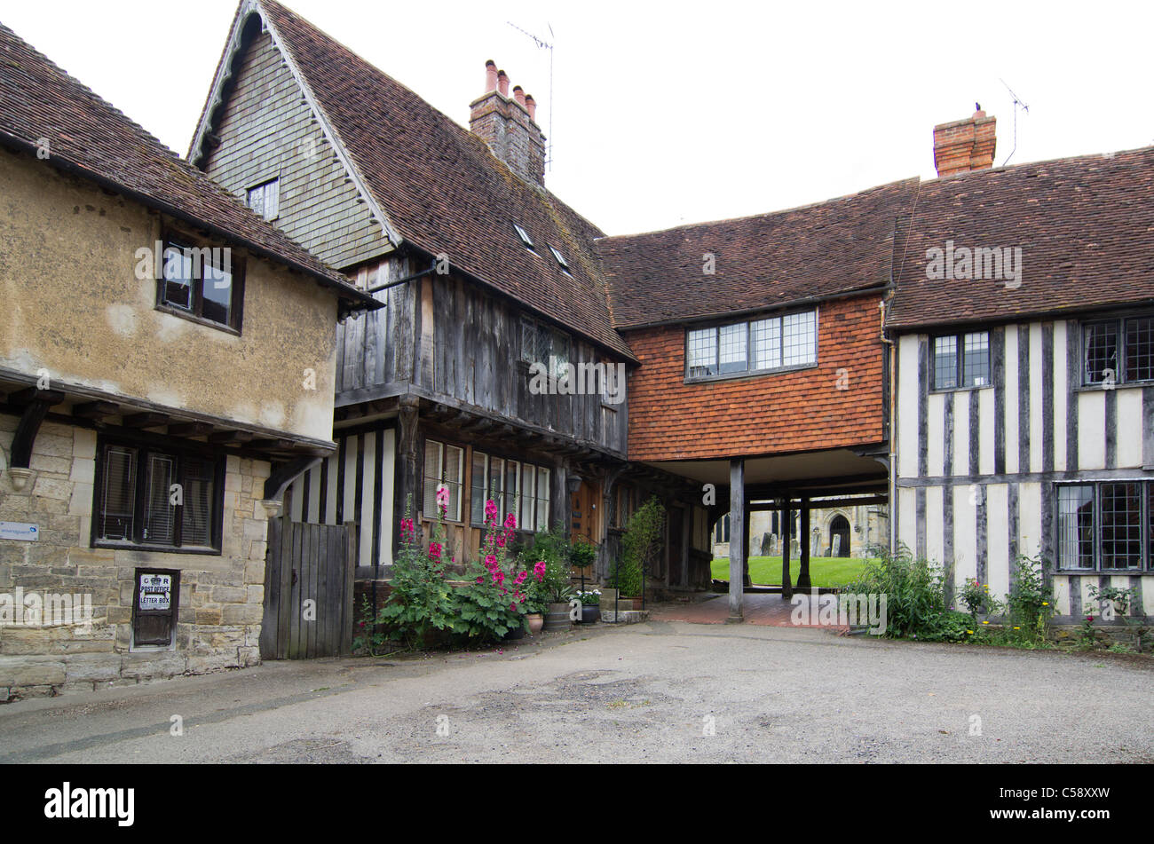 tudor houses and cottages before the churchyard of St John the Baptist