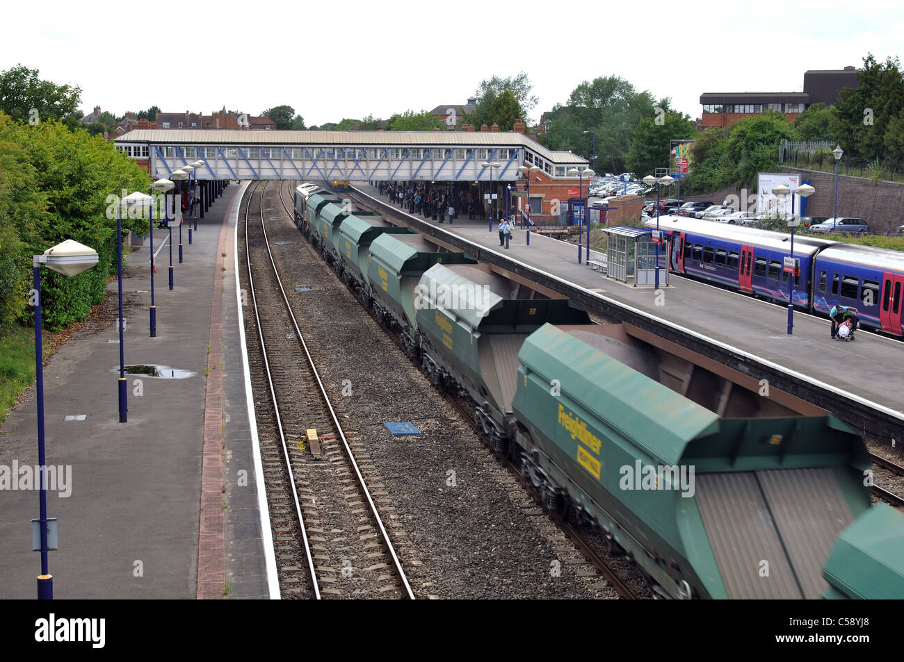 Freight train passing through Newbury station, Berkshire, England, UK