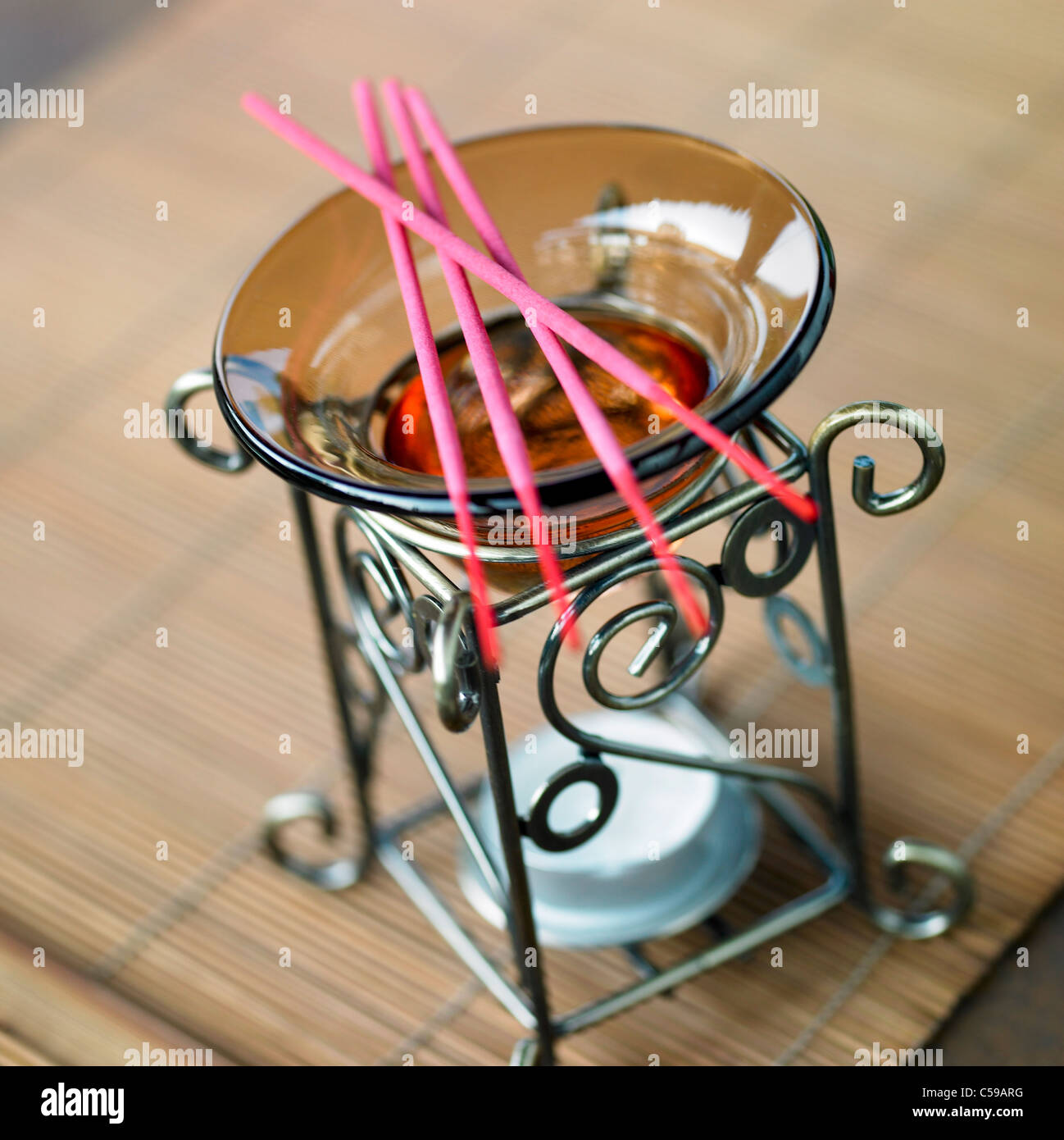 Close-up of incense sticks on oil burner Stock Photo
