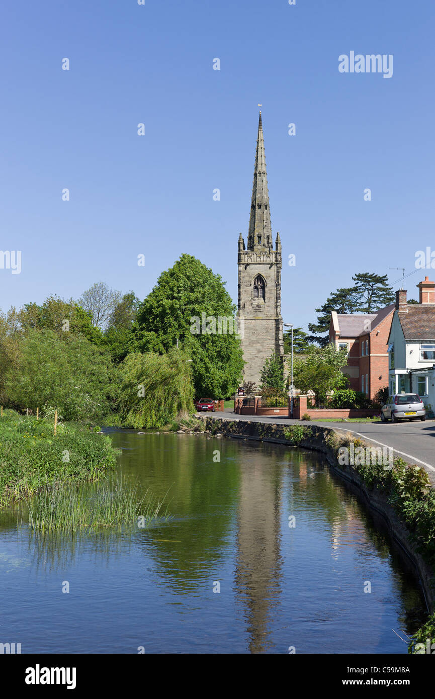 River Anker flows through quintessentially English village of Witherley Leicestershire England UK EU passing St Peter's church Stock Photo
