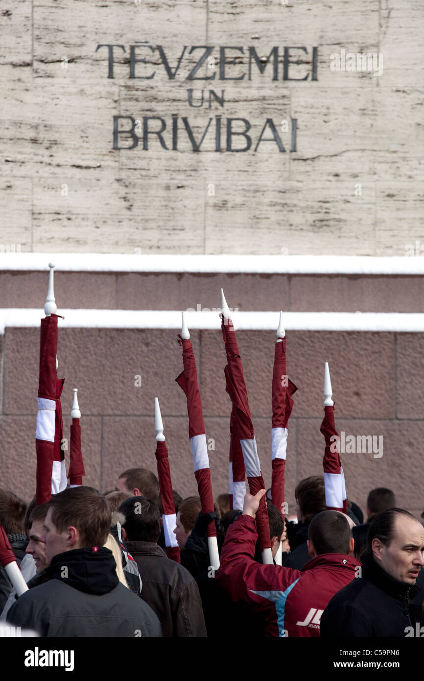 RIGA, LATVIA, MARCH 16, 2010: Latvian flags at Freedom monument. Commemoration of the Latvian Waffen SS unit or Legionnaires.The Stock Photo