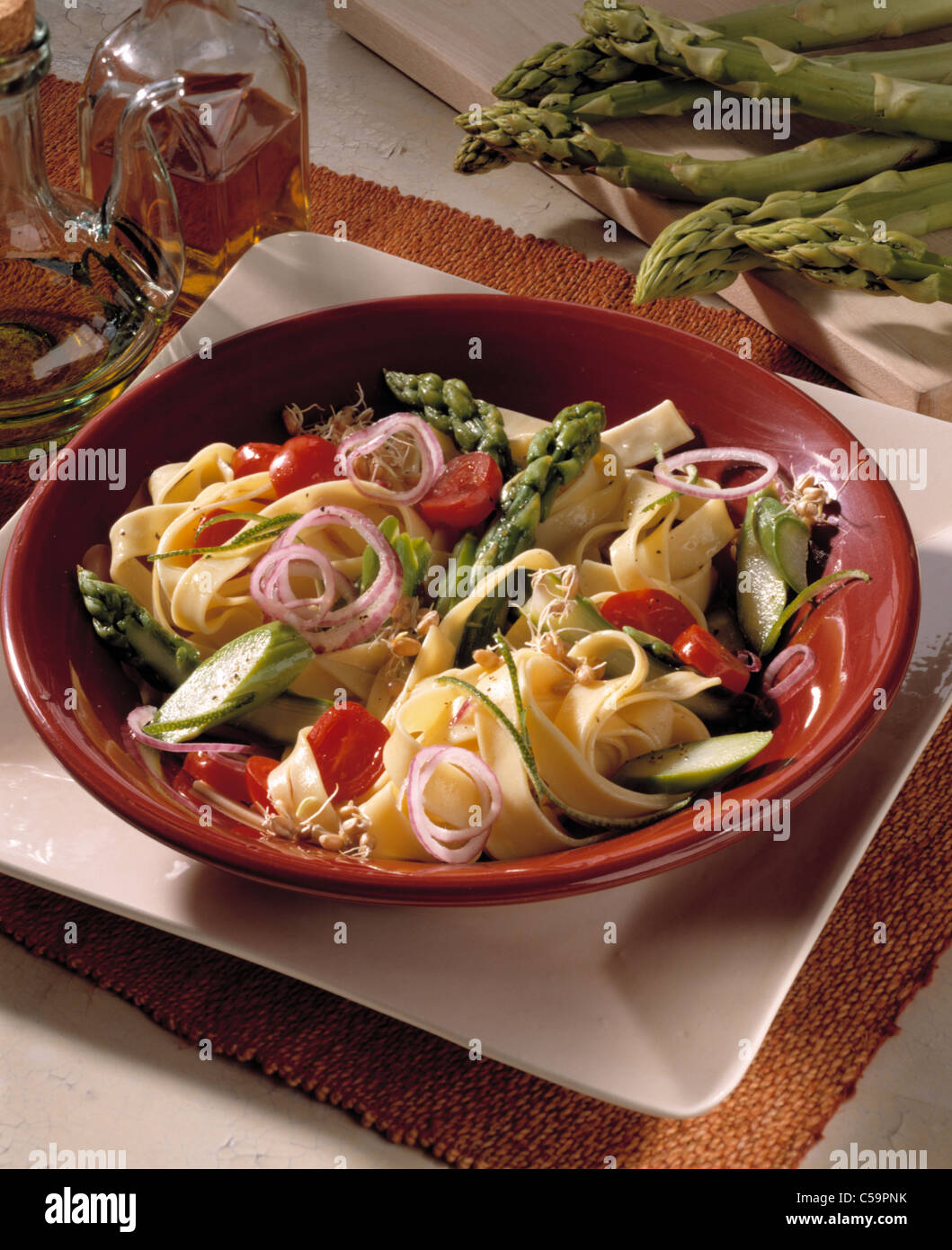 Noodle salad with green asparagus and cherry - tomatos Stock Photo