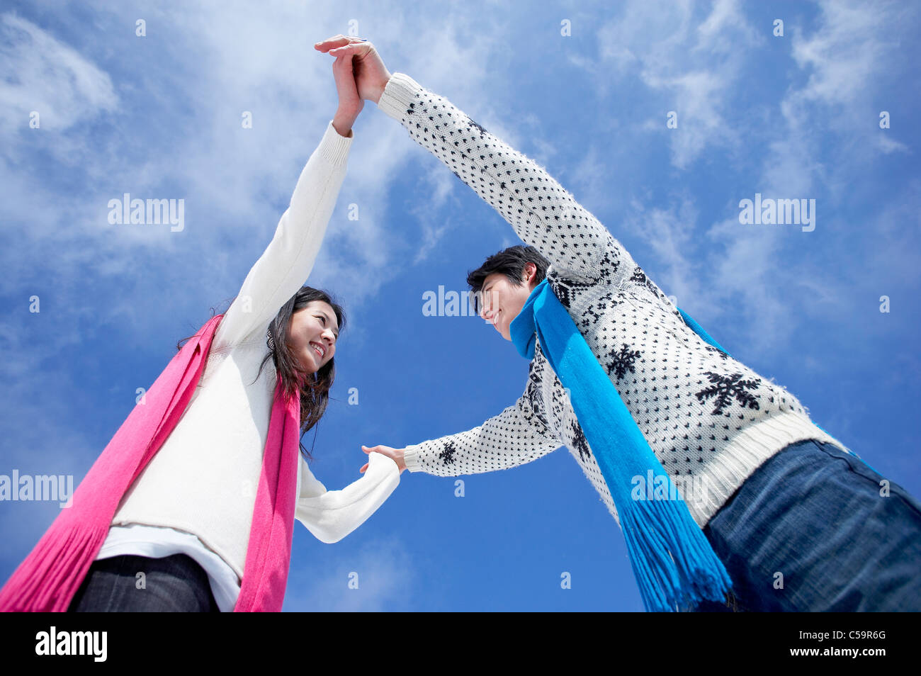 Young man and woman enjoying on snowcapped land Stock Photo - Alamy