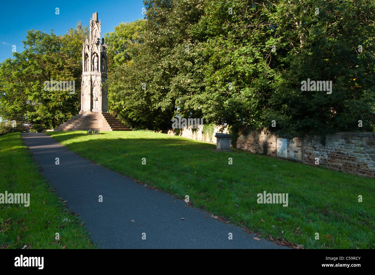 The highly decorated 13th century Queen Eleanor Cross stands beside the