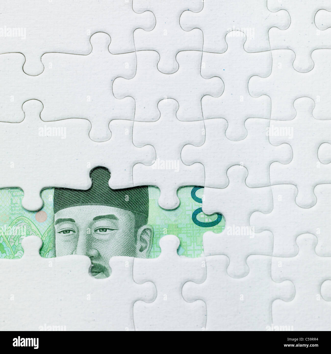 Korean Currency note Behind Jigsaw Puzzle Stock Photo