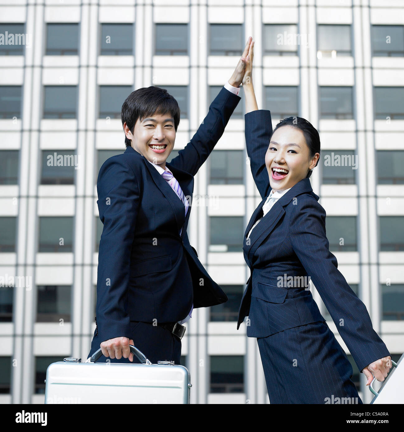 Side view of businesspeople jumping in air Stock Photo