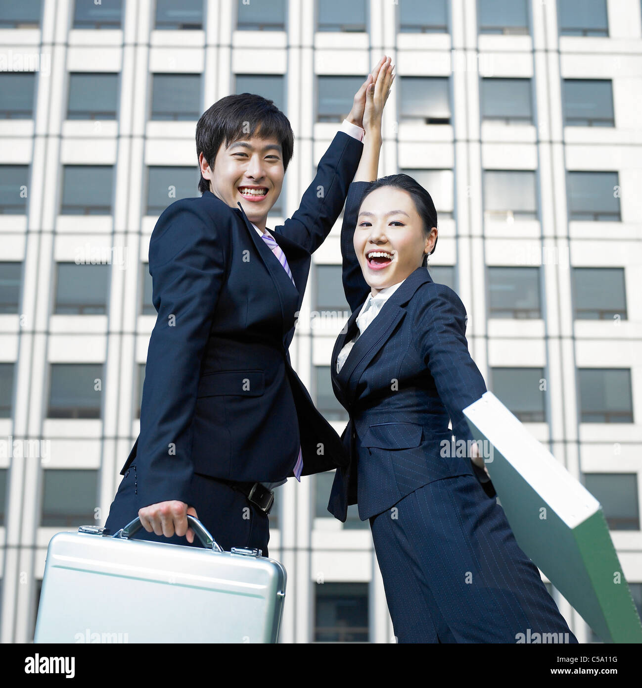 Side view of businesspeople jumping in air Stock Photo