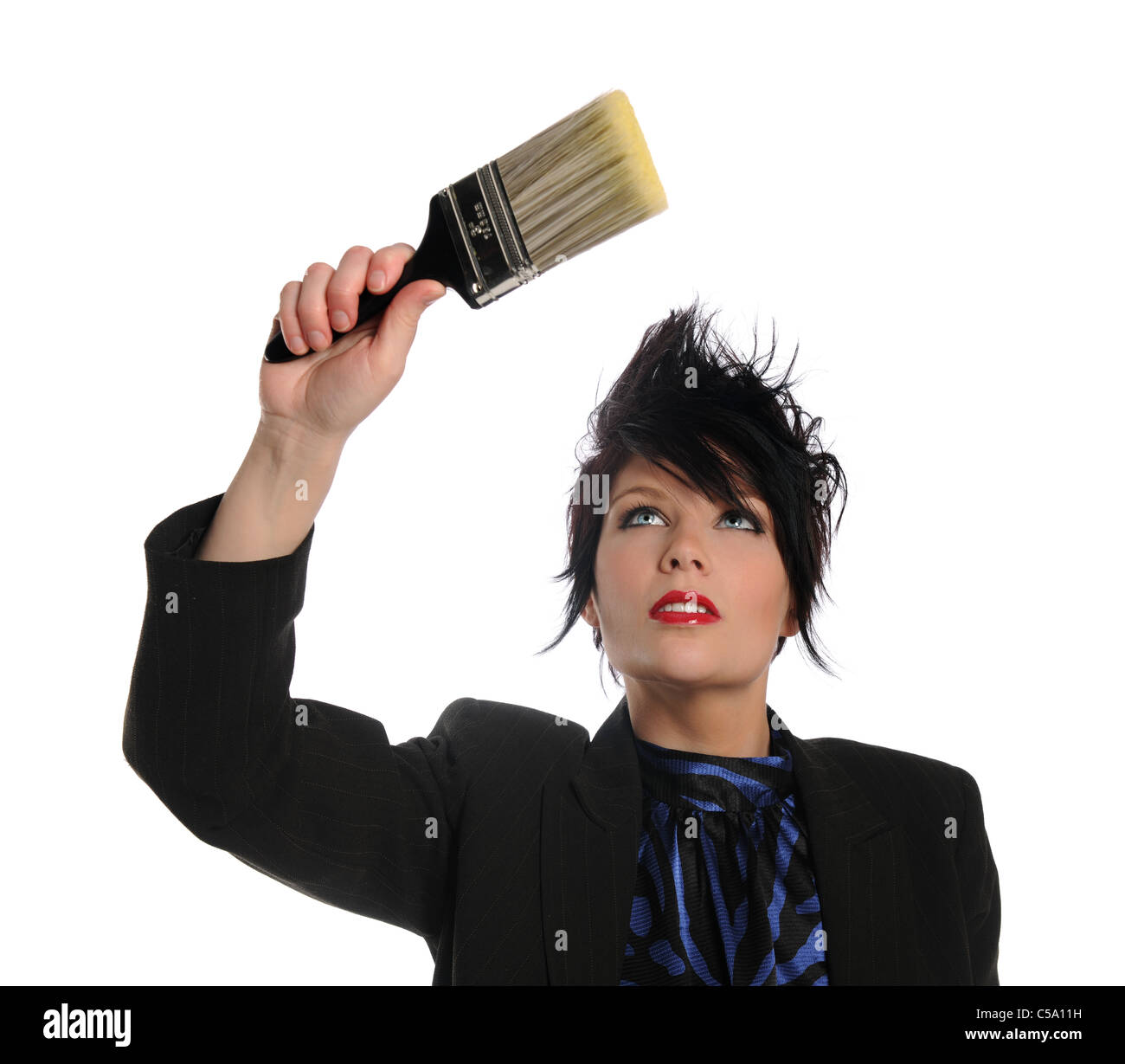 Portrait of beautiful businesswoman with paintbrush isolated over white background Stock Photo