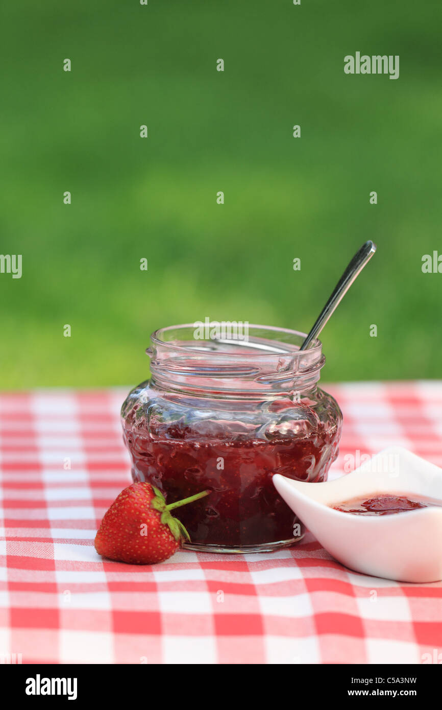 Jar of strawberry jam on the table in the summer garden Stock Photo - Alamy