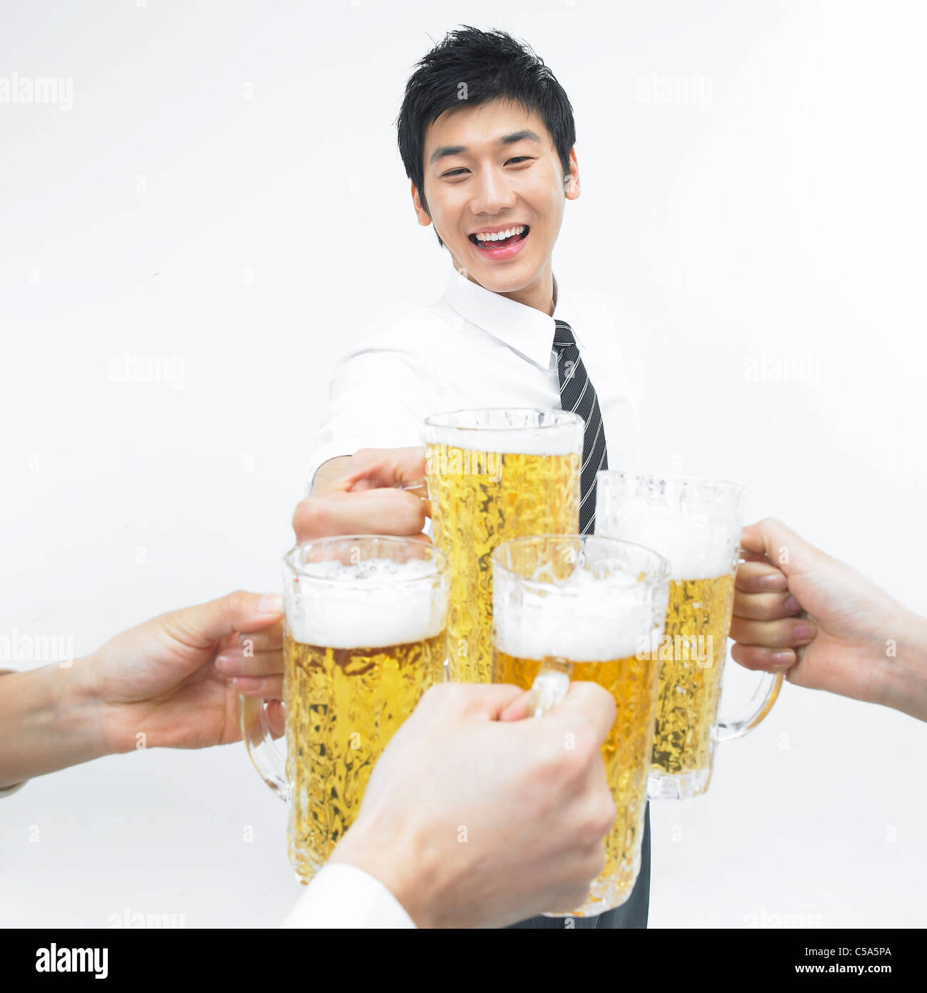 Close-up of young man holding beer glass Stock Photo - Alamy