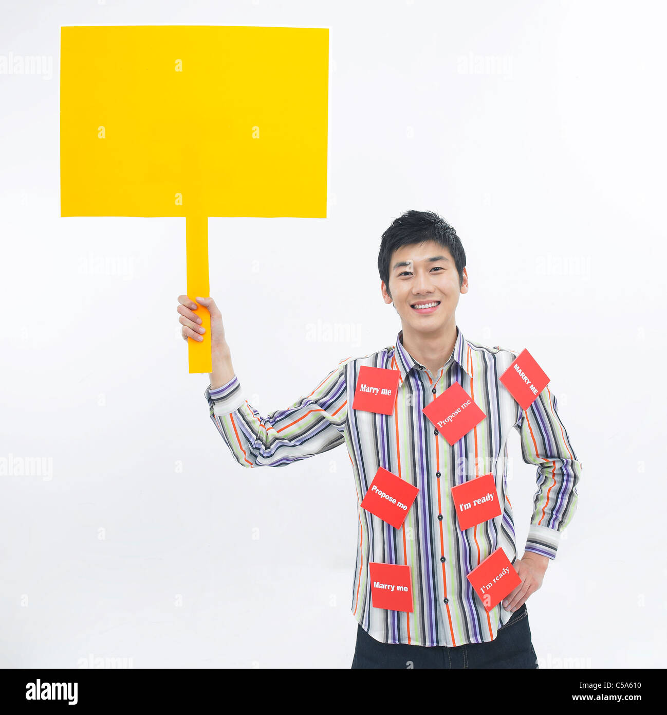 Portrait of young man holding board Stock Photo - Alamy