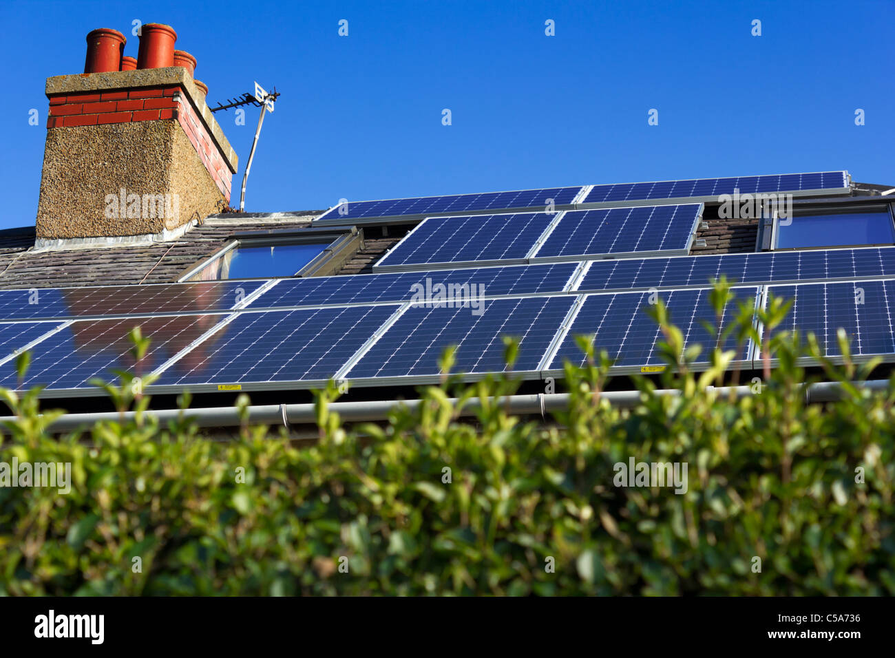 Terraced house with solar panels on roof. Stock Photo