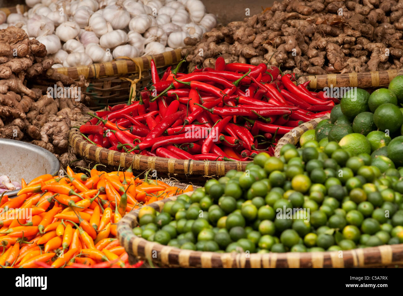 Baskets of chillies, limes, garlic and ginger, Nguyen Thien Thuat St, near Cho Dong Xuan market, Hanoi Old Quarter, Vietnam Stock Photo
