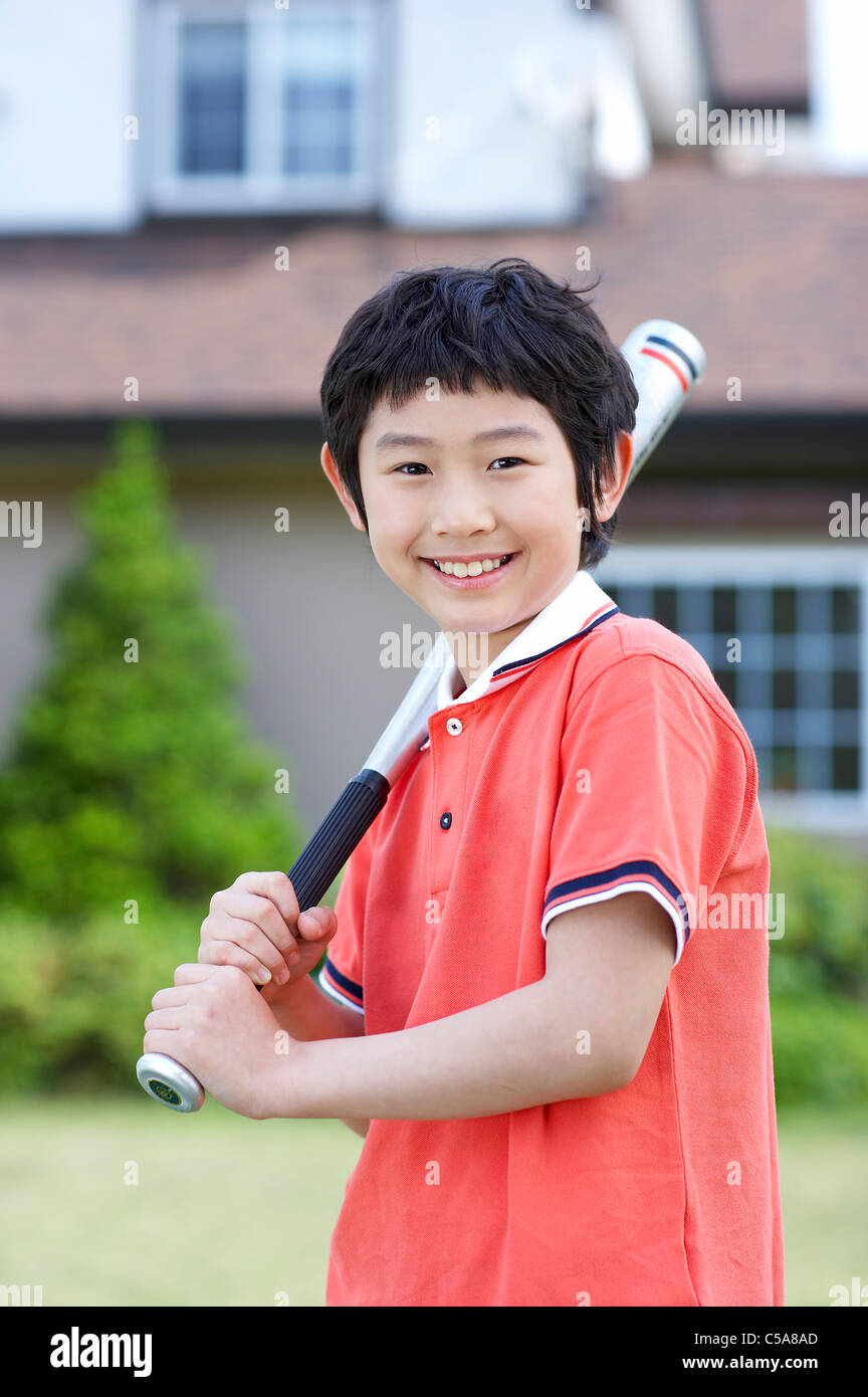 Portrait of boy holding baseball bat Stock Photo Alamy